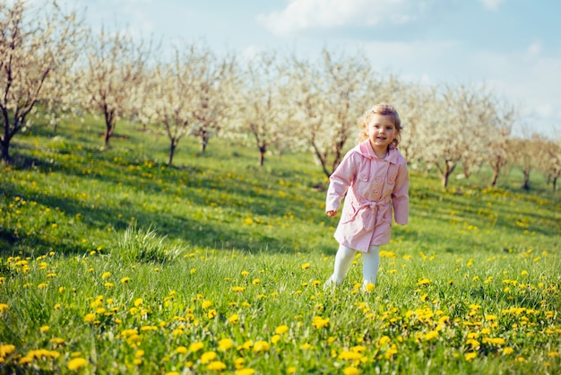 Child outdoors in the blossom trees.