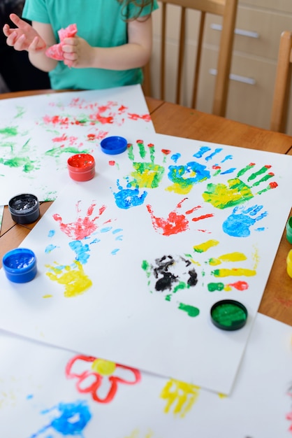 Child painting by his hands