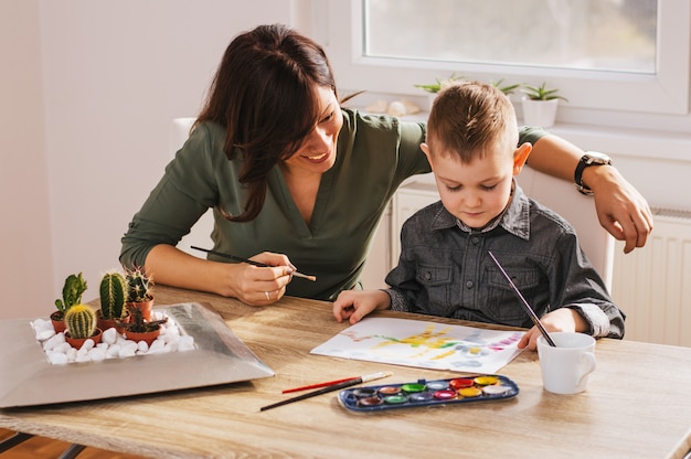 Child painting with mum