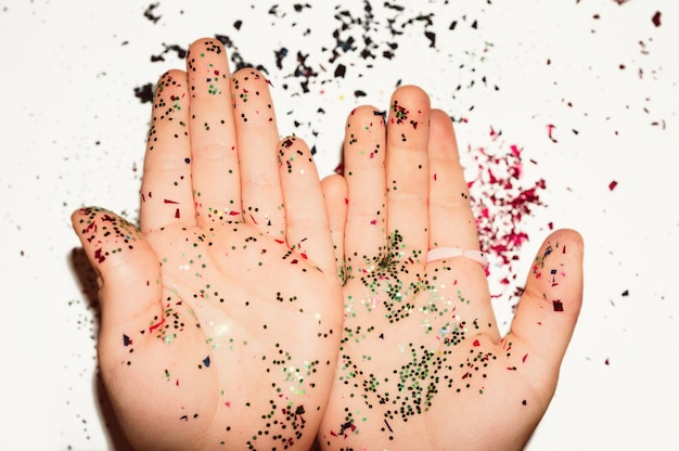 Child palms with glitter on white