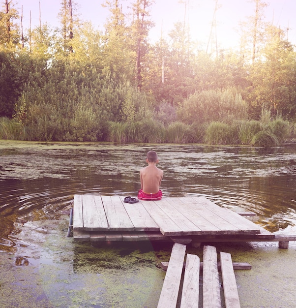 child on piers of lake