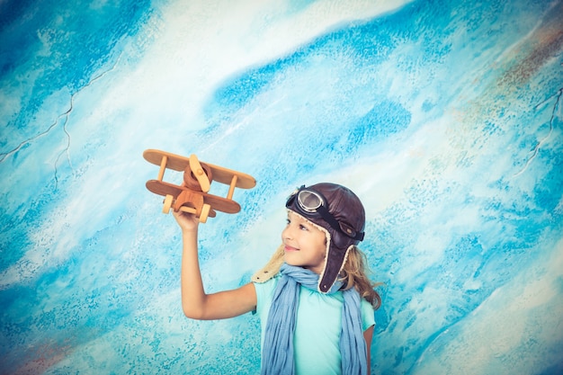 Child pilot. Kid playing at home. Freedom and travel concept. Dream and imagination