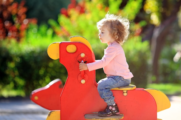 Child on playground in summer park