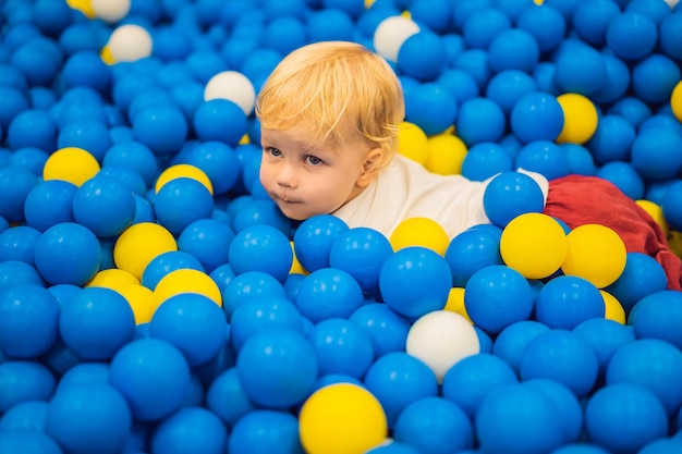 Child playing in ball pit Colorful toys for kids Kindergarten or preschool play room Toddler kid at day care indoor playground Balls pool for children Birthday party for active preschooler