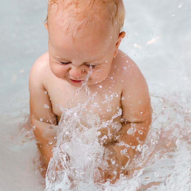 The child playing in the bathroom