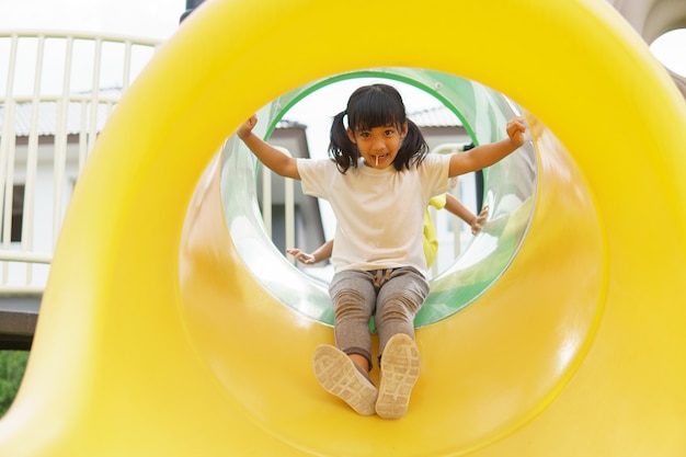 Child playing on outdoor playground. Kids play on school or kindergarten yard.