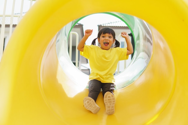 Child playing on outdoor playground. Kids play on school or kindergarten yard