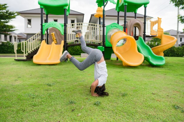Photo child playing on outdoor playground. kids play on school or kindergarten yard.
