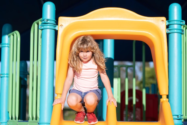 Child playing on the playground in kindergarten joyful kid on the playground