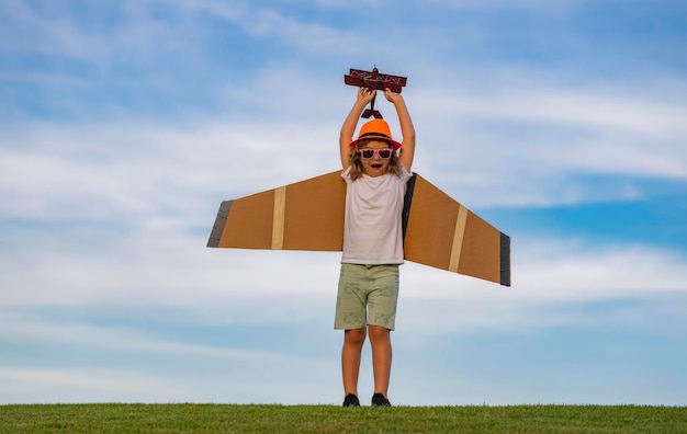 Child playing Portrait of child with toy paper wings outdoor Success creative and start up concept