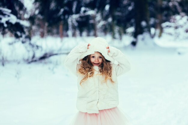Child playing on a winter walk 