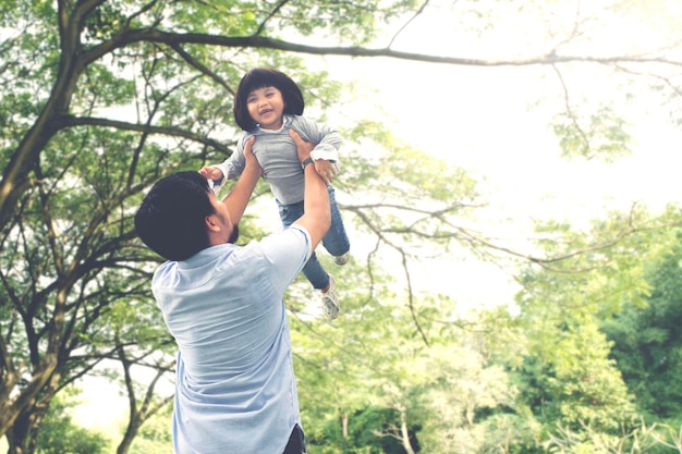 Child playing with her father in the park