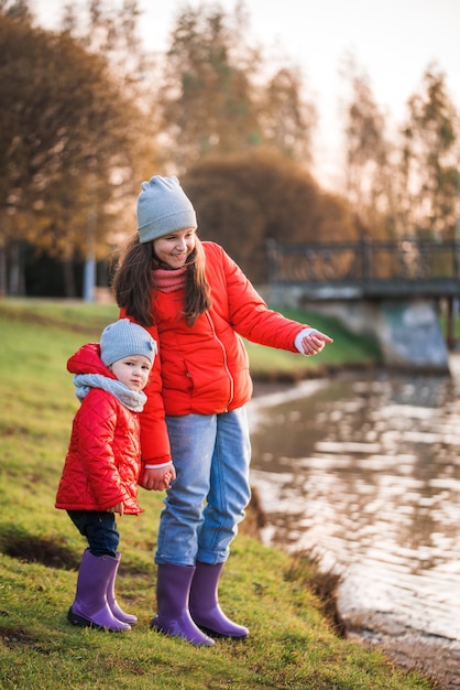 Child playing with paper boats in spring water.lake or river