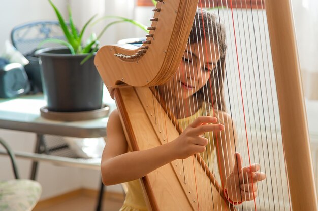 The child plays the harp Selective focus