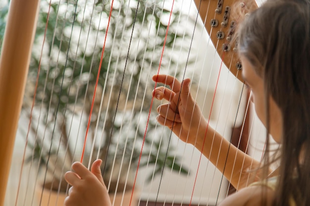 The child plays the harp Selective focus