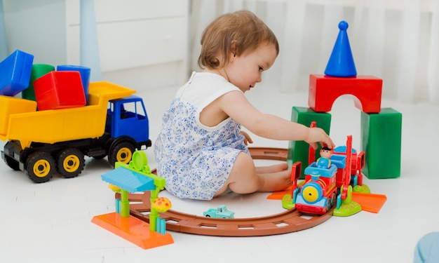 Child plays in the room on the floor