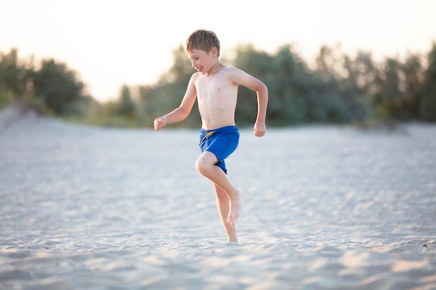 A child plays on the sandy shore Boy playing on the beach