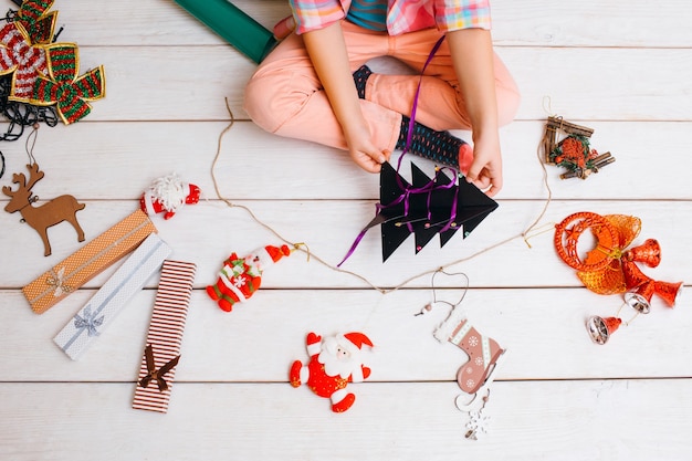 Child preparing for Christmas creatin decor