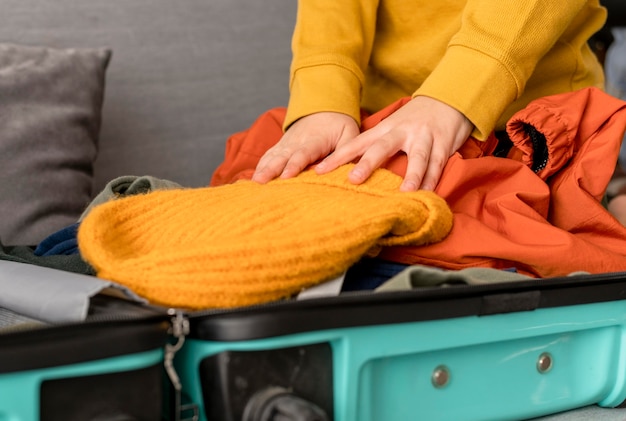 Photo child preparing luggage at home for traveling