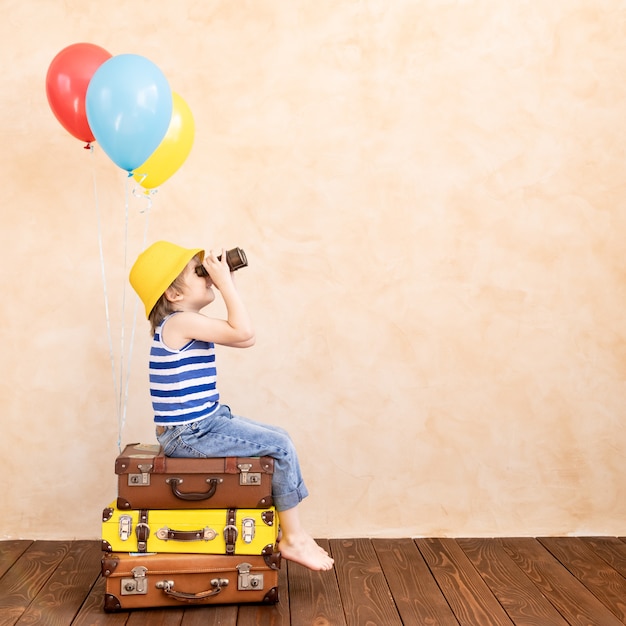 Child pretend to be traveller. Kid having fun at home. Summer vacation and travel concept