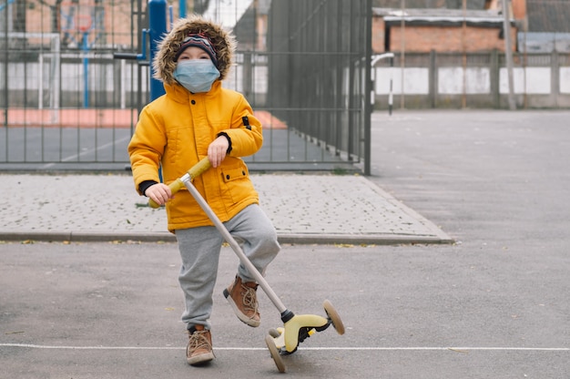 Child in a protective mask on the street