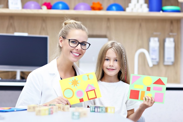 child psychologist working with young girl in office