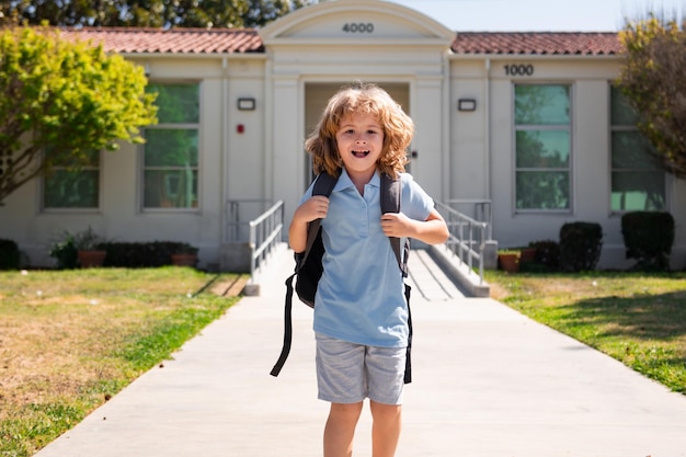 Child pupul with rucksacks in the park near school Schoolboy with backpacks outdoors Knowledge day School uniform