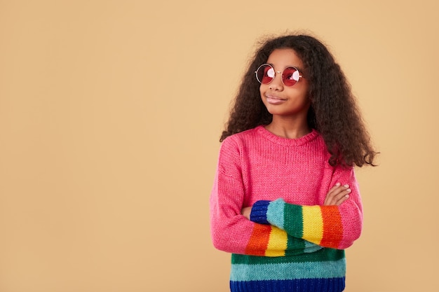 Ребенок в радужном свитере и модных солнцезащитных очках