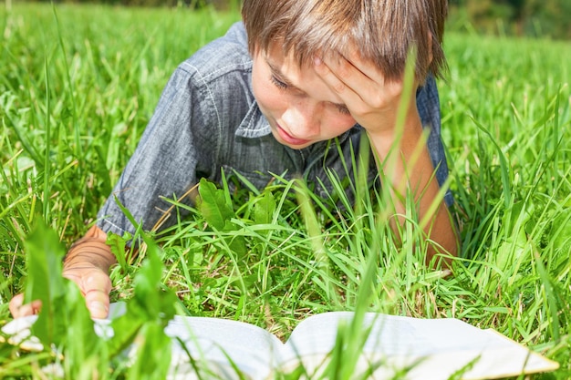 Child reading book outdoor