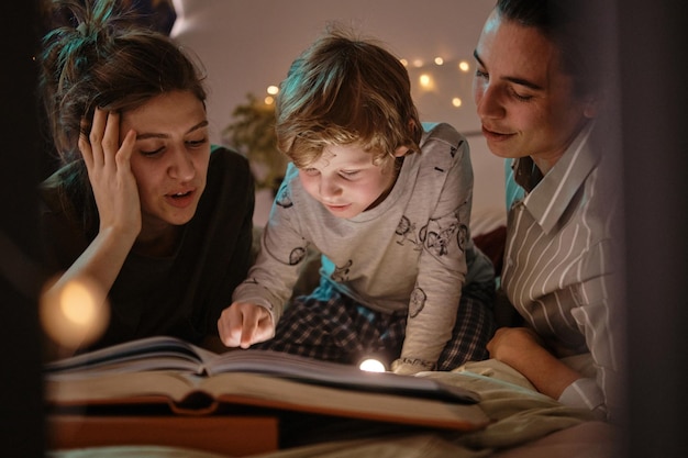 Child reading a tale with parents