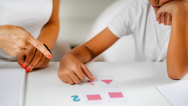 Child recognizing shapes in a preschool assessment test