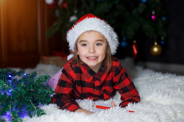 A child in red clothes is sitting waiting for the new year.