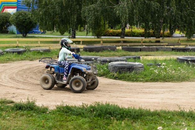 A child rides an ATV on the track