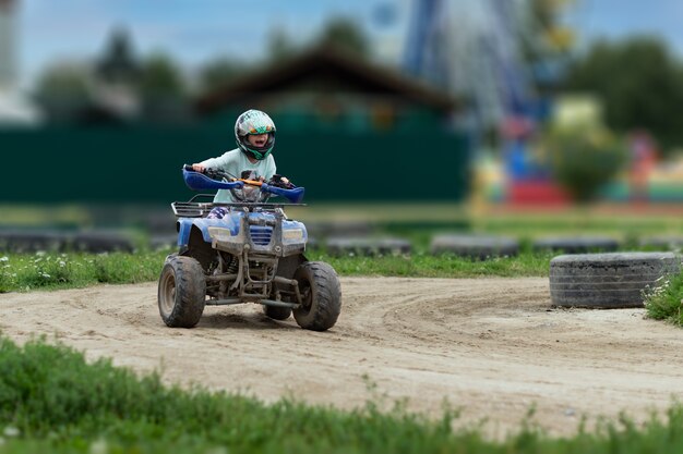 A child rides an ATV on the track