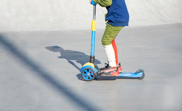 A child rides a kick scooter playground for riding on kick scooter