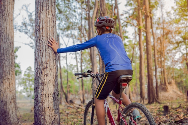 Child riding a mountain bike in the woods.