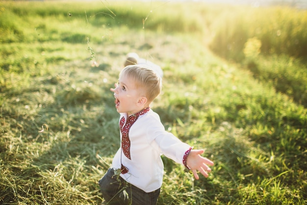 Child running happily by the field