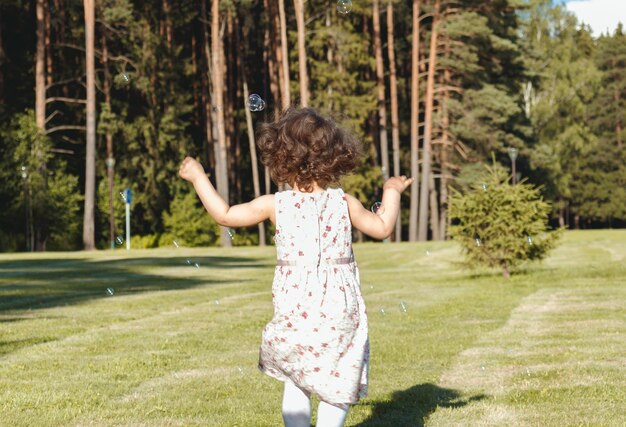 A child runs through the grass on a summer day