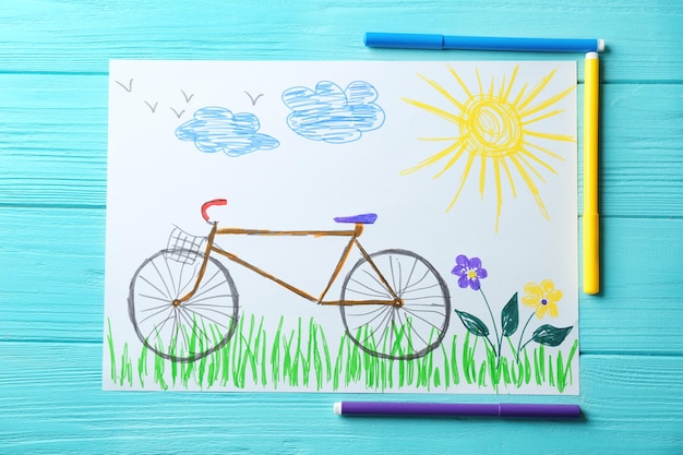 Child's drawing of bicycle on blue background