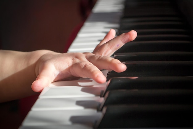 Child's hands on the piano.