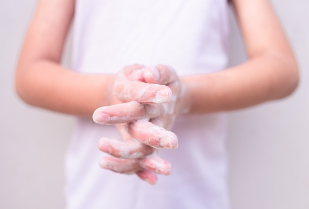 Child's hands washing their hands. Personal hygiene, cleansing the hands.