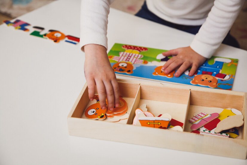 Premium Photo | Child's hands with colorful board game on the white ...