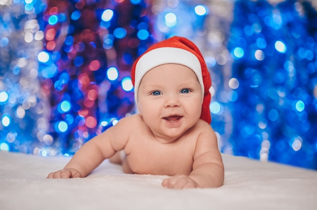 Child in Santa hat with festive sparkling tinsel