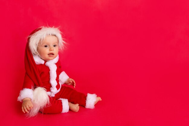 Child in a Santa suit in studio