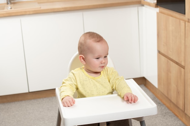 Child Sitting at Empty Table