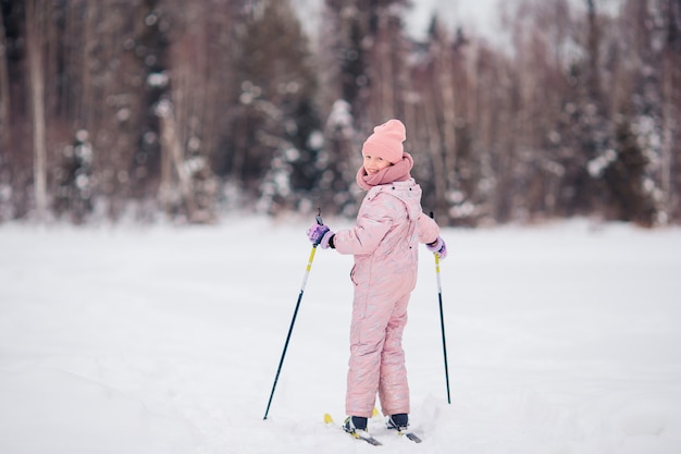 Child skiing in the mountains. Winter sport for kids.