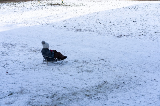 A child sledding down a hill