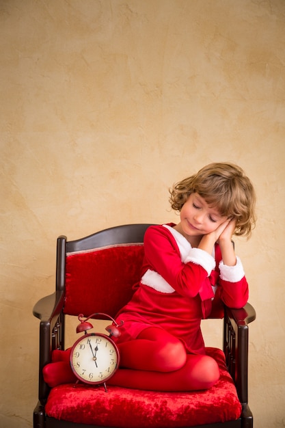 肘掛け椅子で寝ている子供。クリスマスプレゼント。クリスマスの休日の概念