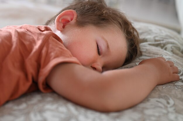 Photo the child sleeps on his stomach during the day.