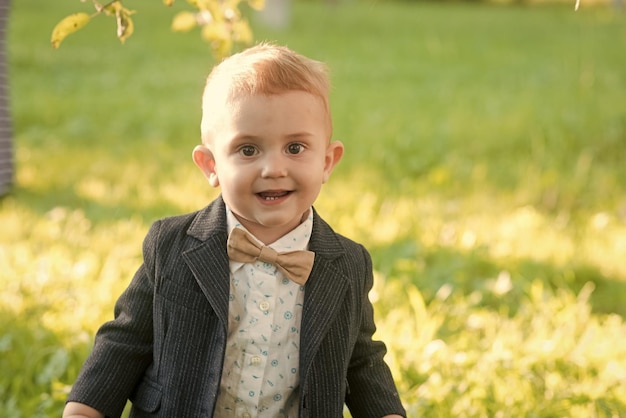 Child smile with bow tie on summer day, vacation